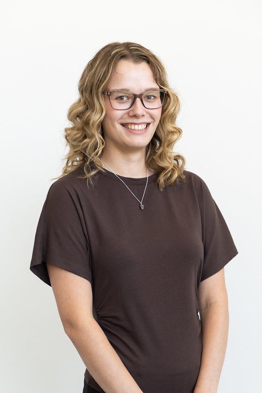 blonde caucasian woman in a brown top