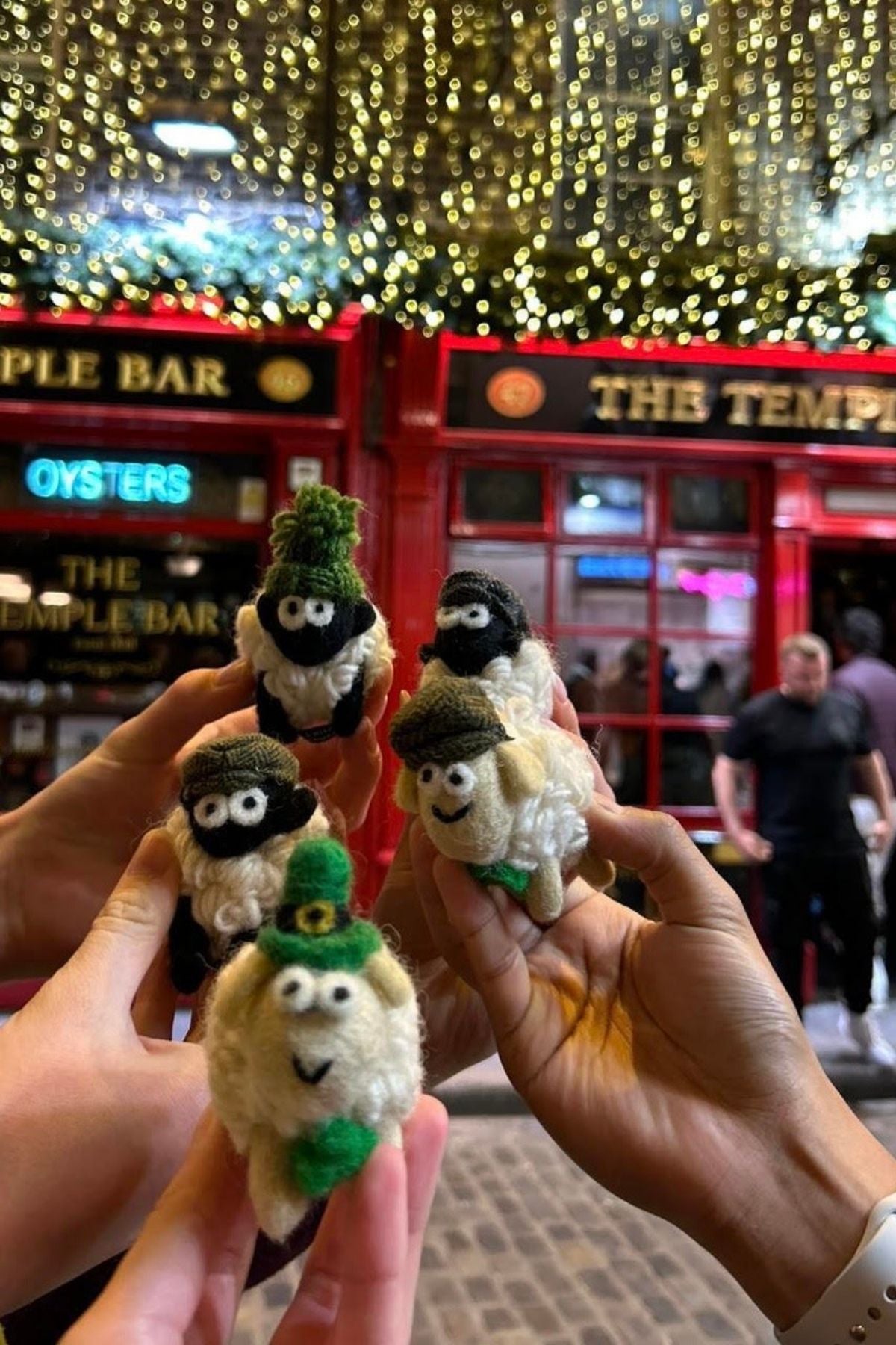Hands holding sheep trinkets