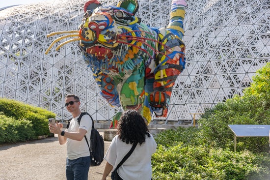 Student in front of sculpture 