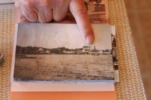 A finger pointed at an old photo.