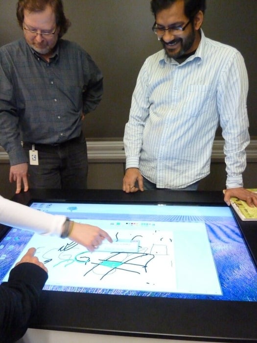 People playing with an interactive table.