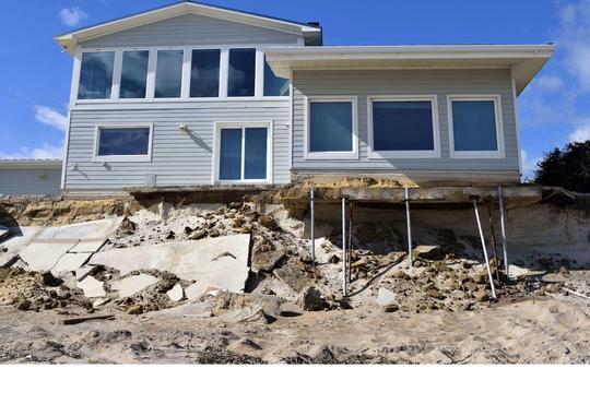 A beach house with its foundation eroded