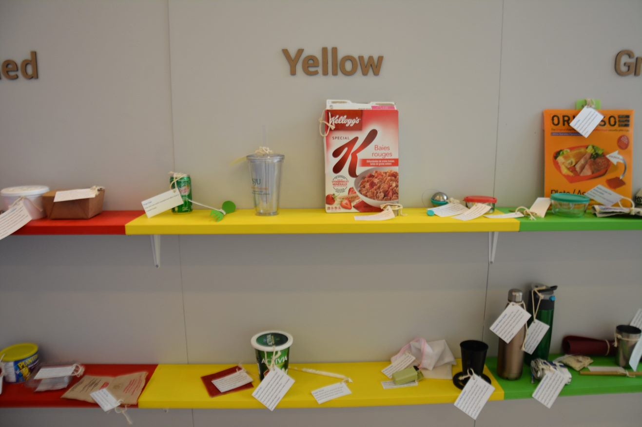 Different types of waste showcased on shelves at the exhibit 