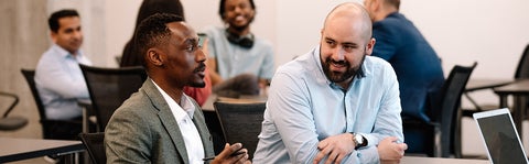 Two students in the MBET program chatting