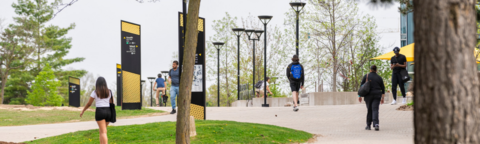 Students walking across the outdoor pathways of the UW campus