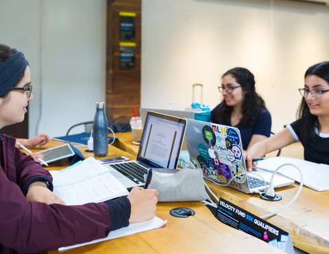 three brown girls on their computers