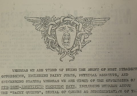 Scanned image of an excerpt from the first few lines of the first Radicalqueens manifesto. Above the few lines of text is a stylized emblem depicting a grimacing head surrounded by intertwined snakes, hair, and vines, with wings.