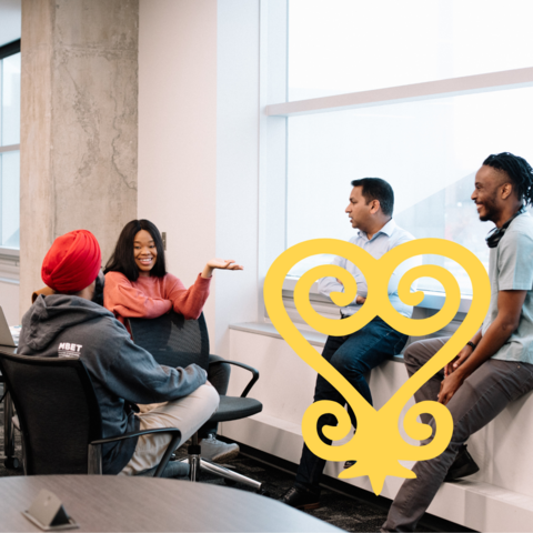 A group of 4 students in conversation with a yellow Sankofa heart icon.