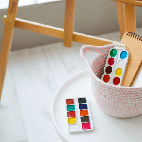 Paint supplies stored in a white basket