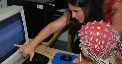 Professor with participant looking at monitor