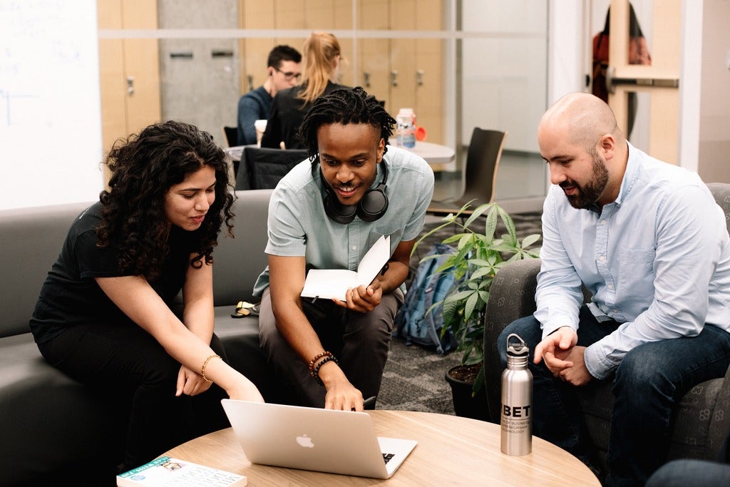 Students looking at a laptop