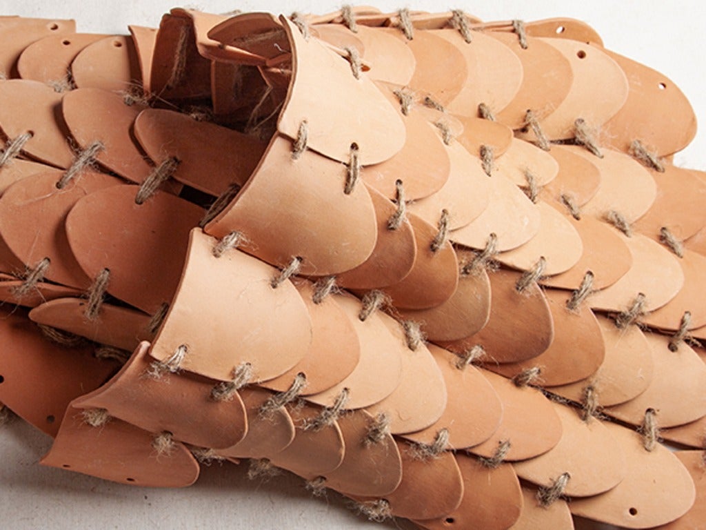 Curved tiles connected by rope