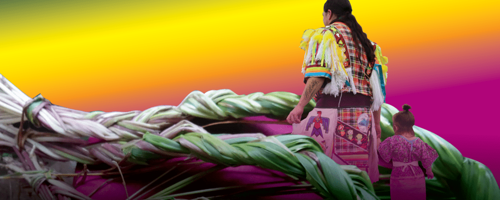 A person holding a child's hand walking amongst weavings
