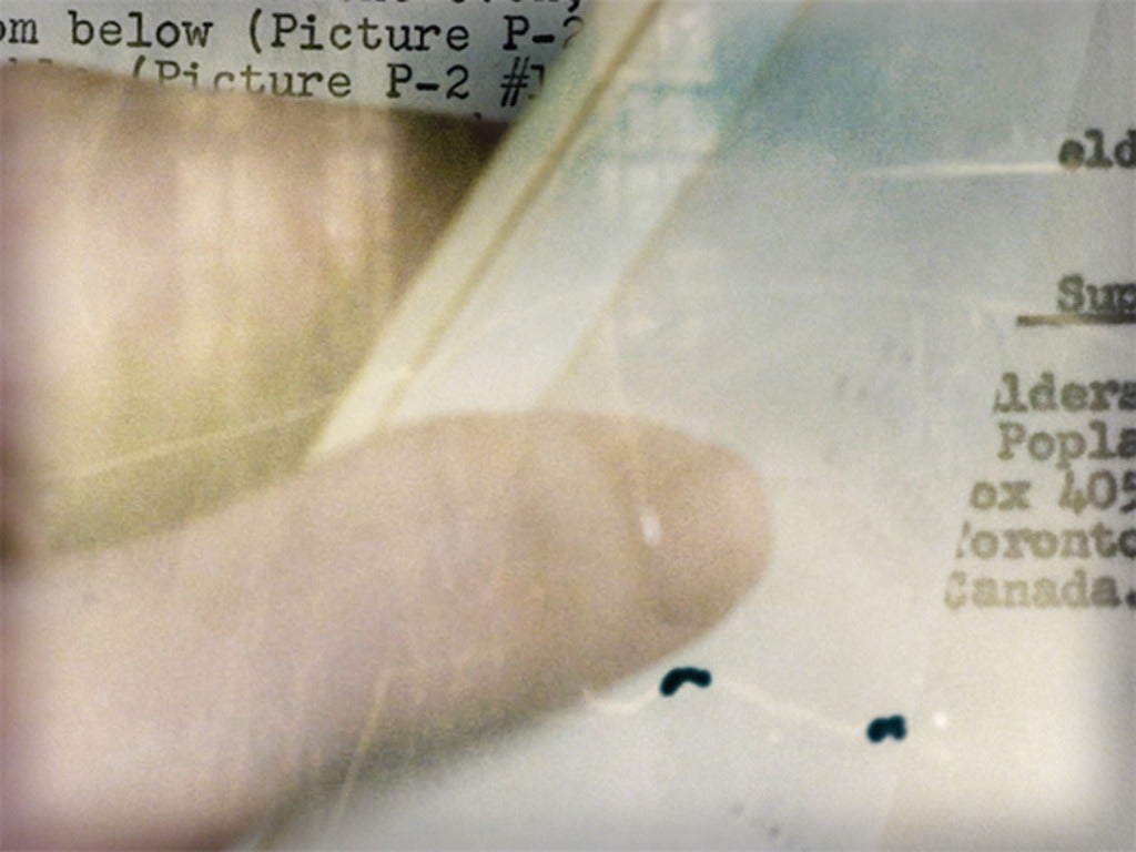 Close up of a thumb holding the page of a book open
