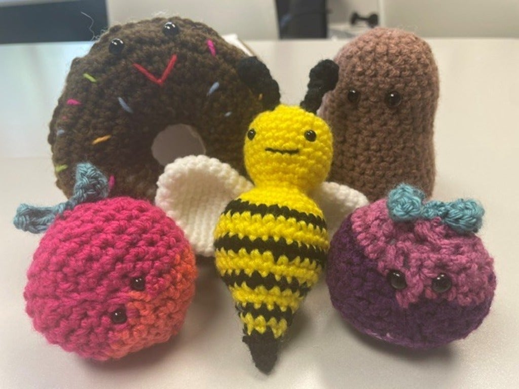 Crocheted bumblebee, donut, potato, and beat