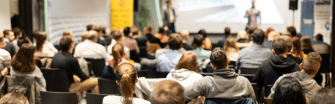 Person presenting and people watching