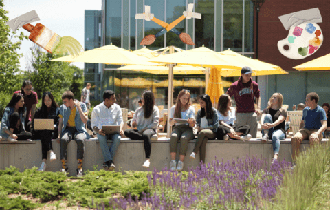 people sitting on a barrier outside on Waterloo campus