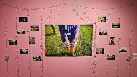 exhibit of photos and lights on wall