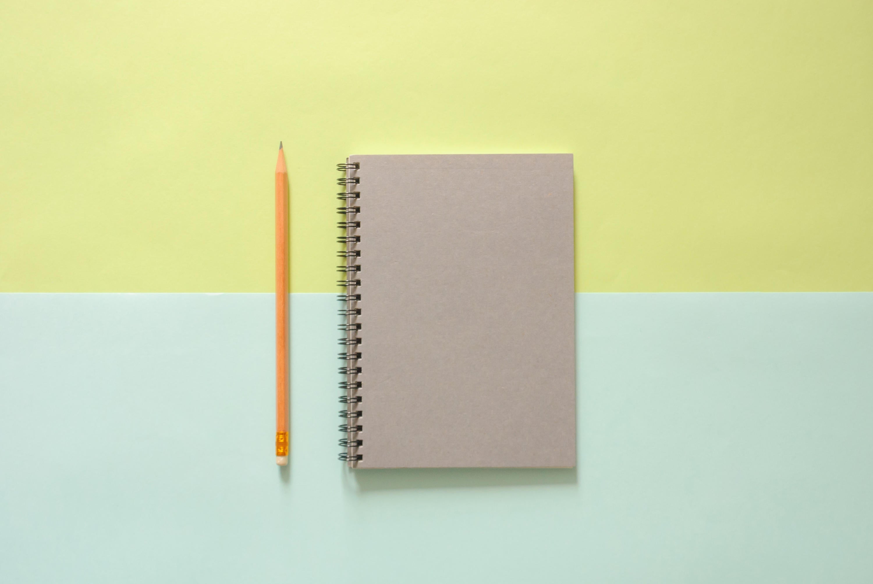 Notebook with pencil beside it