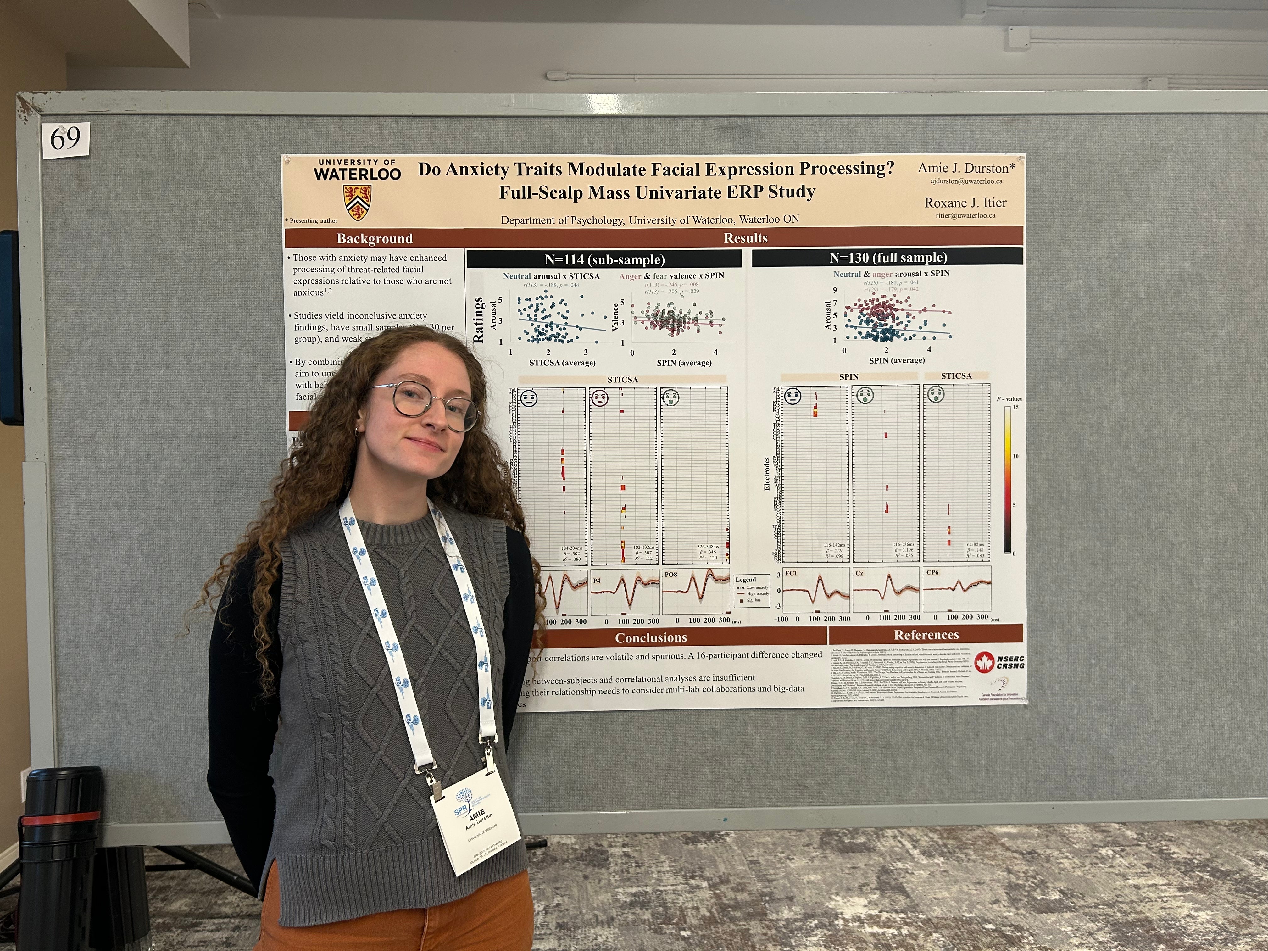 Amie standing at her poster