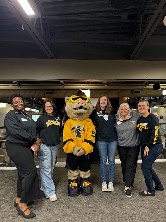 group of people with mascot