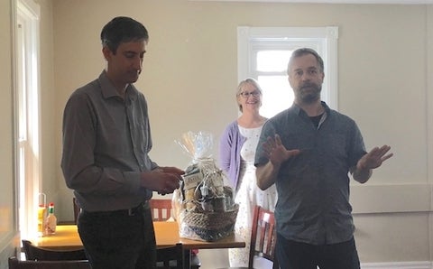 Benoit Charbonneau accepting a gift from members of the Lecturers Committee, presented by chair Paul Wehr and Cynthia Tremblay.