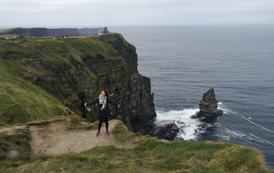 Student in front of the Cliffs of Moher in Scotland