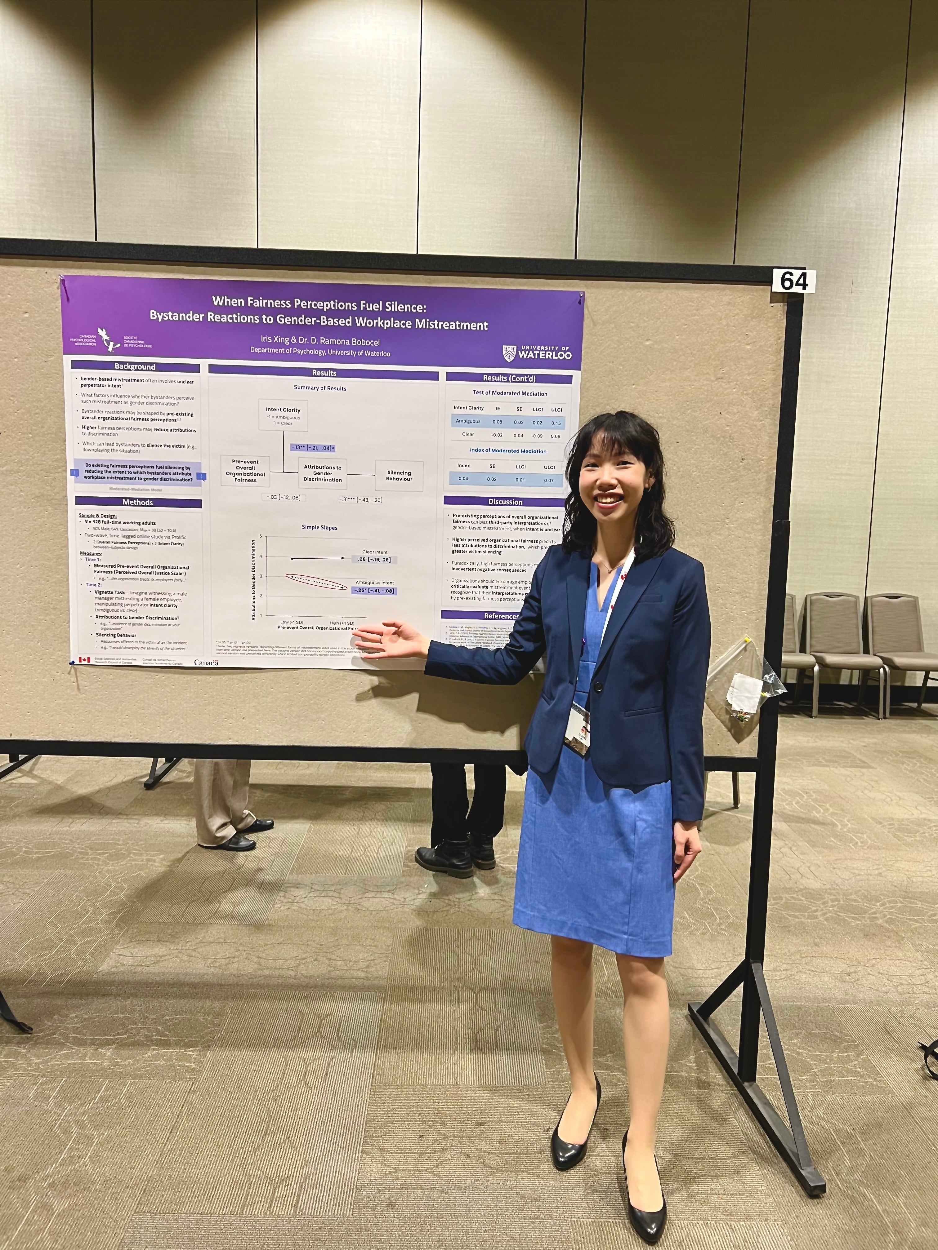 Iris standing besider her poster at CPA Conference 2025