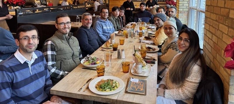 The Fatigue Stress and Analysis Lab sitting for a meal at a group event.