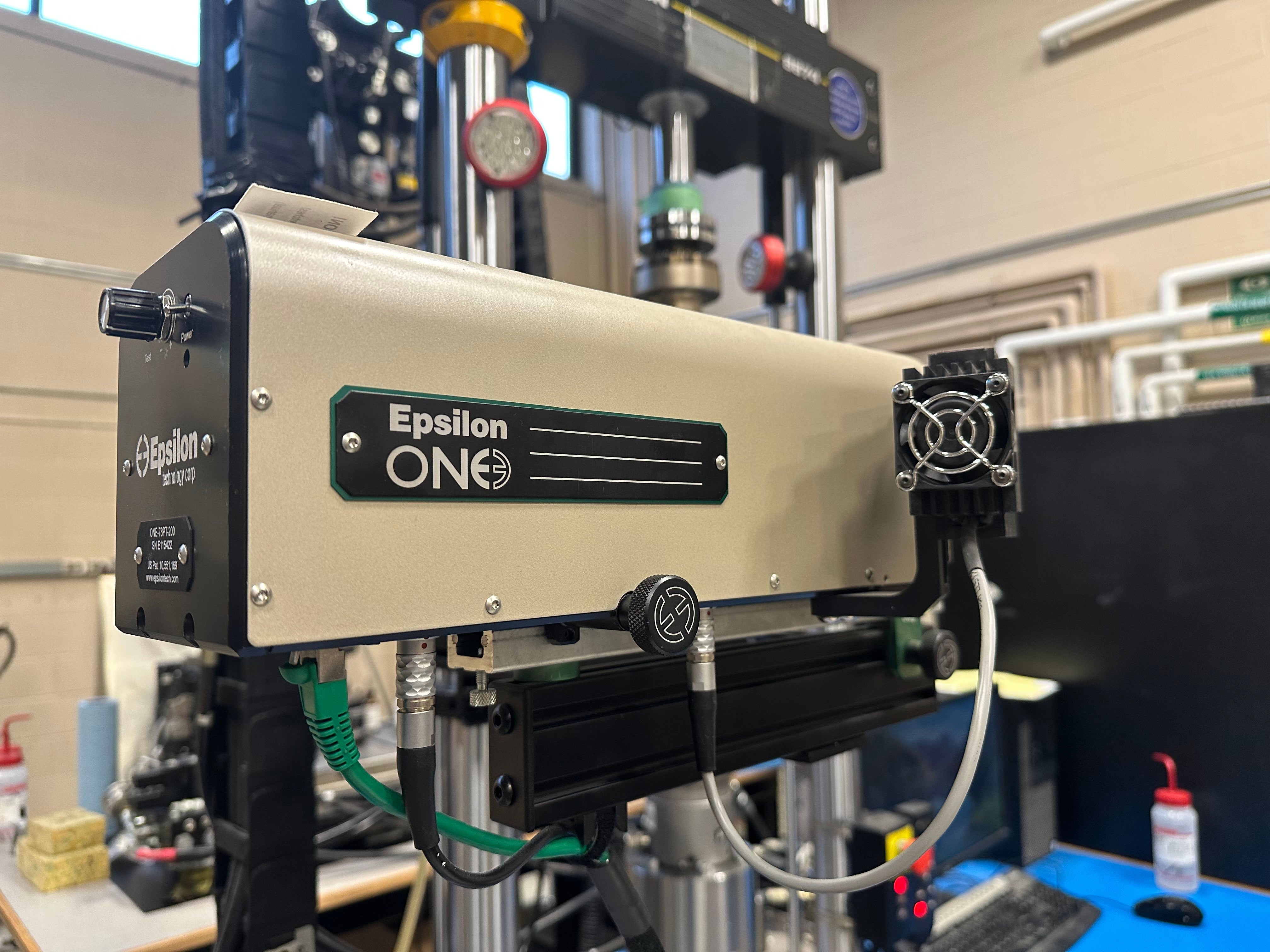 Epsilon ONE video extensometer attached to axial testing machine.