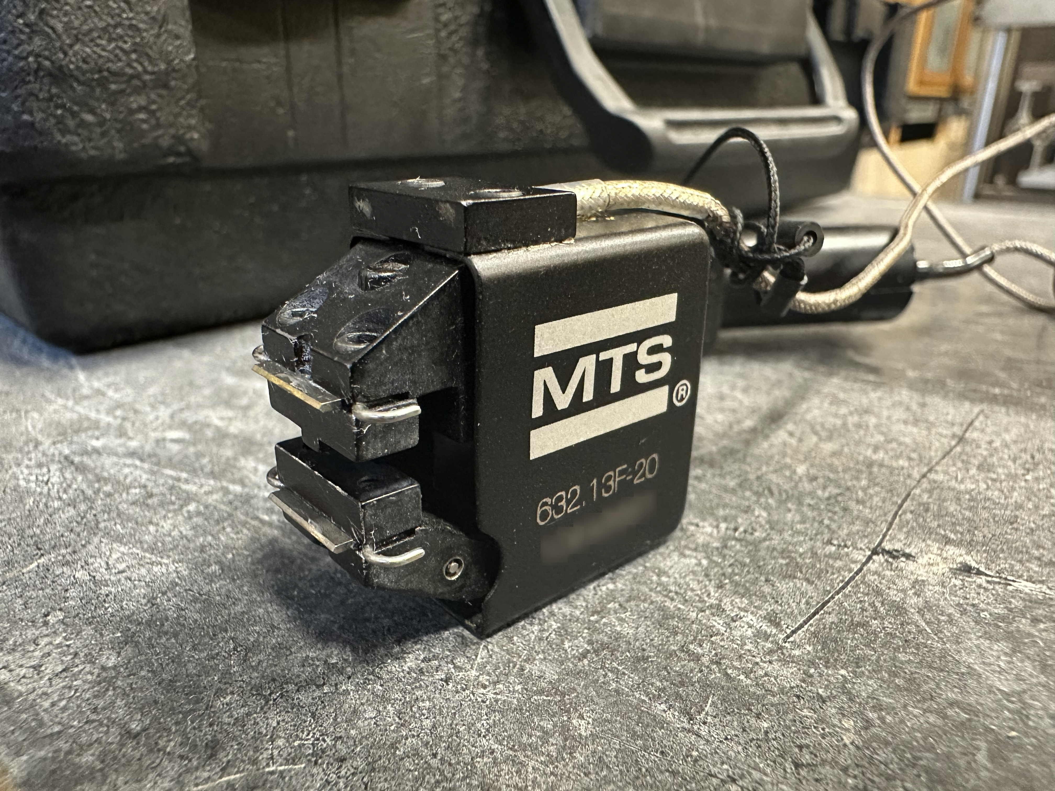 A black, short extensometer.