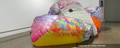Artwork made of brightly coloured and patterned fabric, inflated sculpture on a gallery floor.