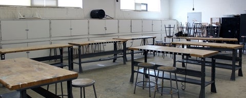 Bright industrial room and empty wood tables and stools.