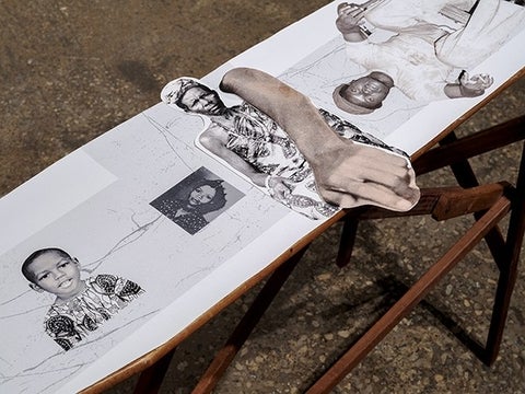 Partial view of family photos collaged and overlaid on top of a vintage wooden ironing board.