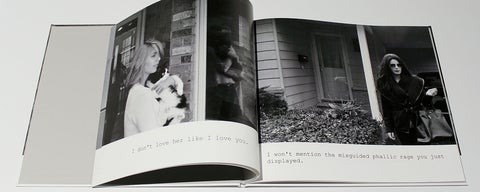 Open book with black and white photographs of a woman holding a cat and a woman in dark glasses leaving a house. Text reads: I don't love her like I love you; I won't mention the misguided phallic rage you just displayed.