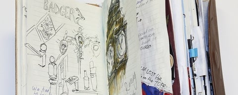 Half opened sketchbook with written notes and a drawing of Big Ben clock in London.