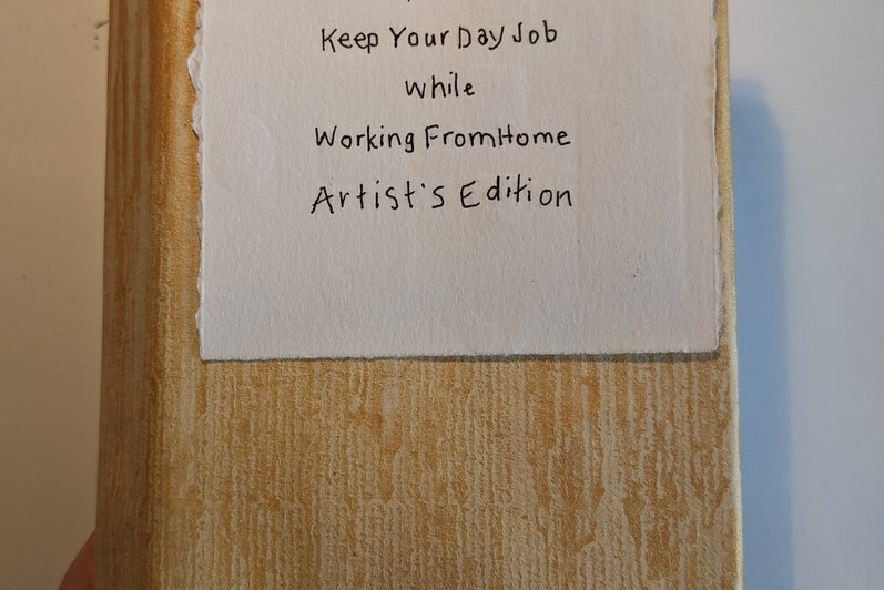 Accordion style book closed, cover text "How to keep your day job while working from home, Artist's Edition