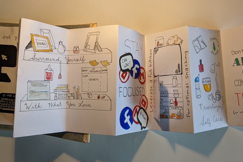 Accordion style book opened to pages  with line drawings and text, 