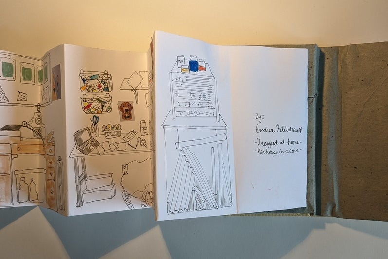 Accordion style book opened to back pages showing desks and tables with art supplies, Text Andrea Filiatrault Trapped at home,