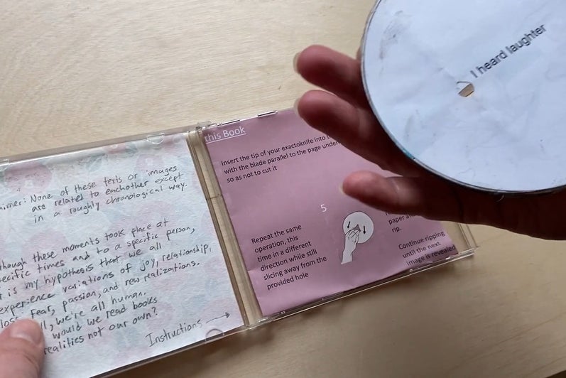 Artwork, open CD case with text and circular work reading "I heard laughter" 
