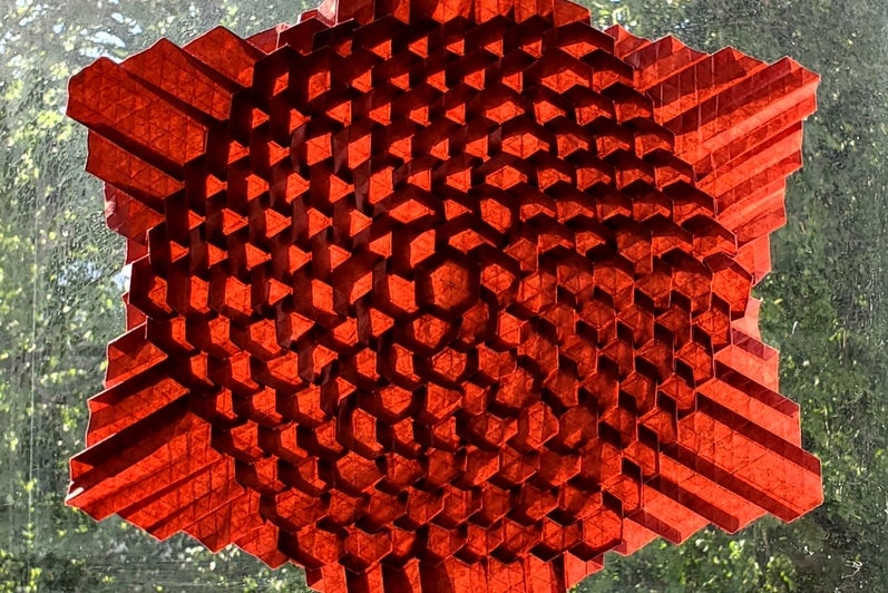 Red six pointed star with textured surface.