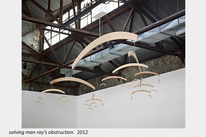 Artwork by Lois Andison.  solving man ray’s obstruction.  2012, Routered maple hangers, stainless steel rod, bearings, bushings 