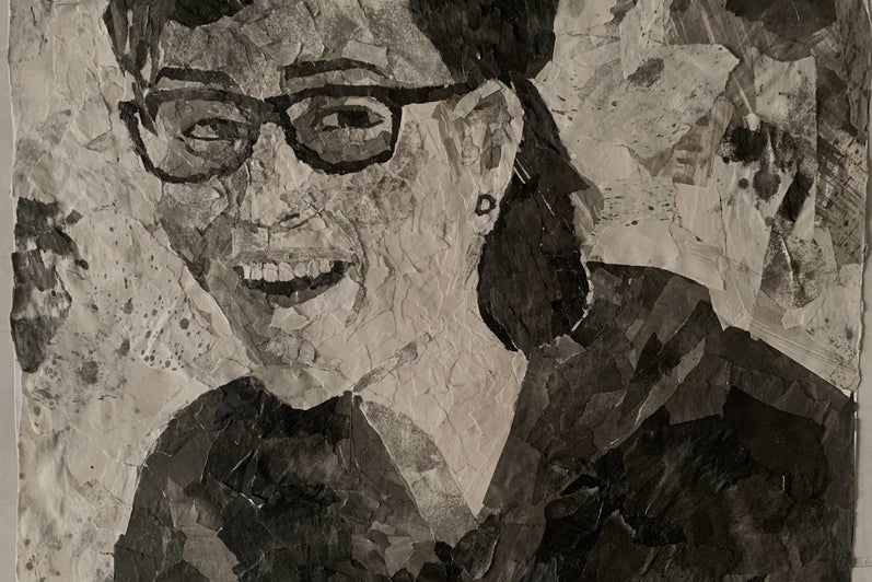 3/4 view portrait of person composed of collaged pieces of black and white patterned paper. Person smiling and wearing glasses 