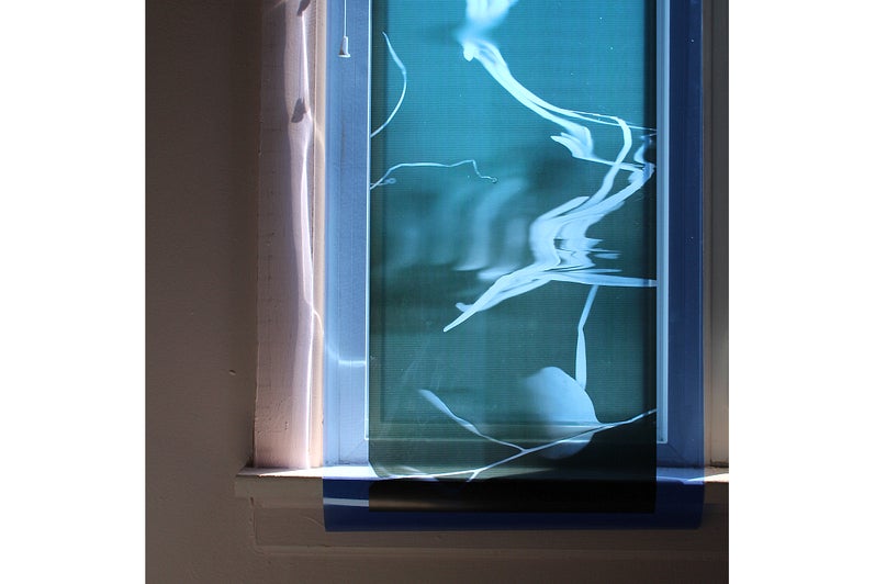 Window cover with transparent blue film.