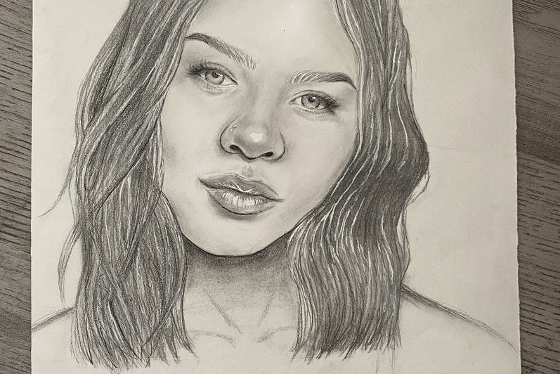 Portrait drawing showing person facing straight ahead with a faint smile and head tilted to the right.