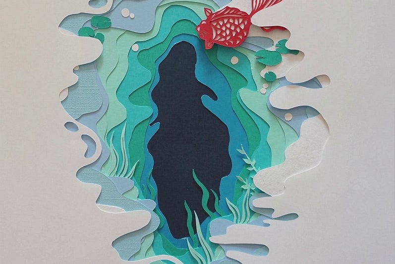 Paper cut-out artwork, white paper cut to reveal pages in shades of blue and green like water, orange carp swims.