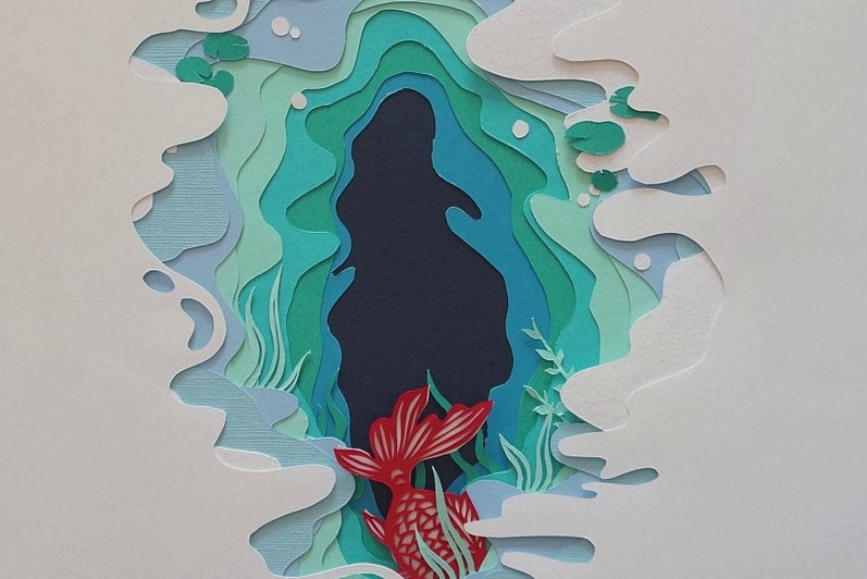 Paper cut-out artwork, white paper cut to reveal pages in shades of blue and green, orange carp "swims" underneath top paper.