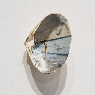 Shell containing a photograph of people at a beach.