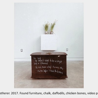 Artwork by Maria Sinmmons - Bone Gatherer. 2017. Found furniture, chalk, daffodils, chicken bones, video projection