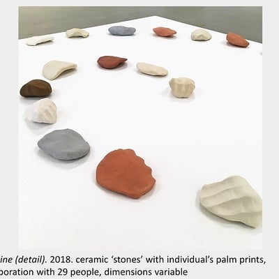 Artwork by Sara Pearson - Life Line (detail). 2018. ceramic ‘stones’ with individual’s palm prints, collaboration with 29 people